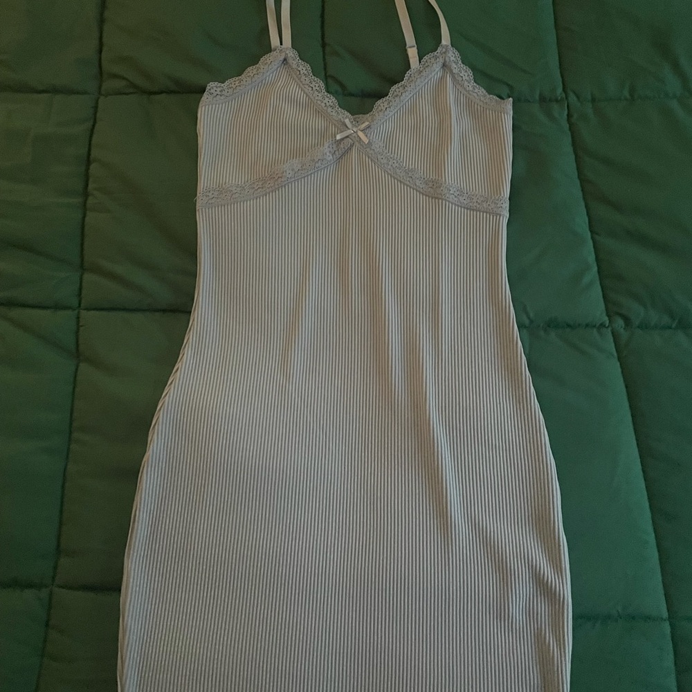 Never worn, blue lacey outlined dress with a tie in the middle.